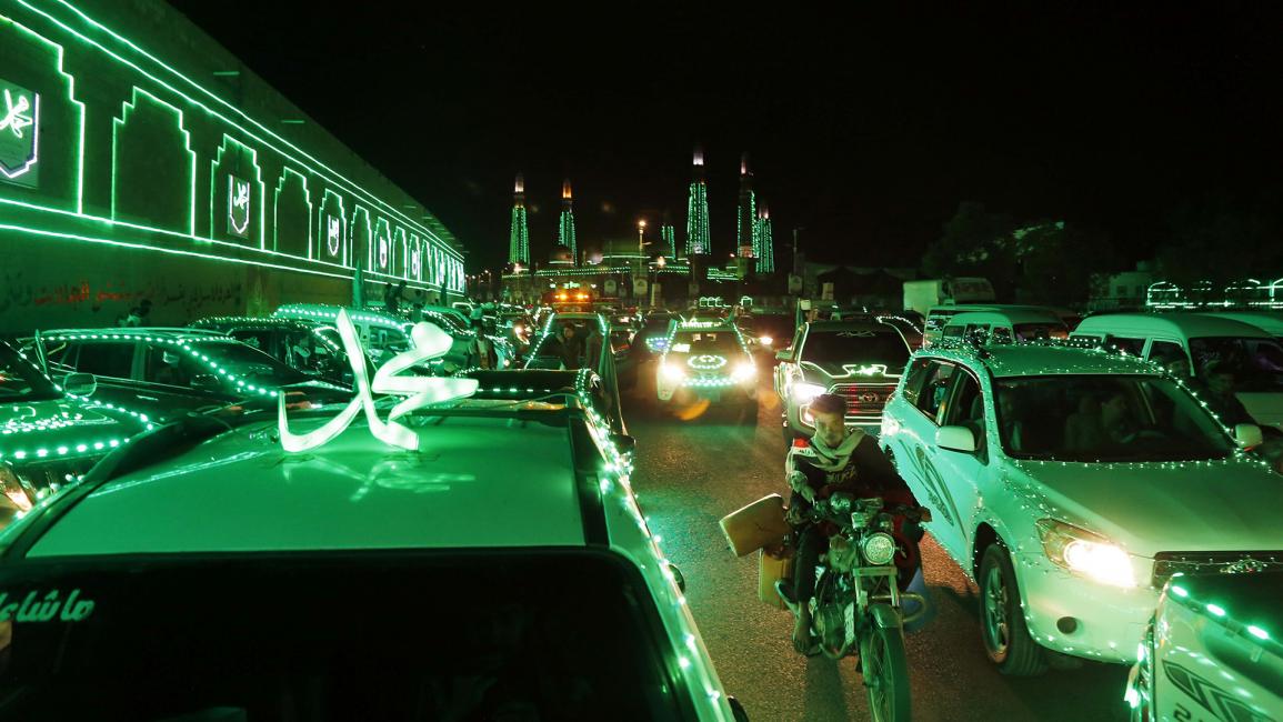 مركبات ومبانٍ مزينة بأضواء خضراء في العاصمة اليمنية صنعاء (محمد حمود/Getty)