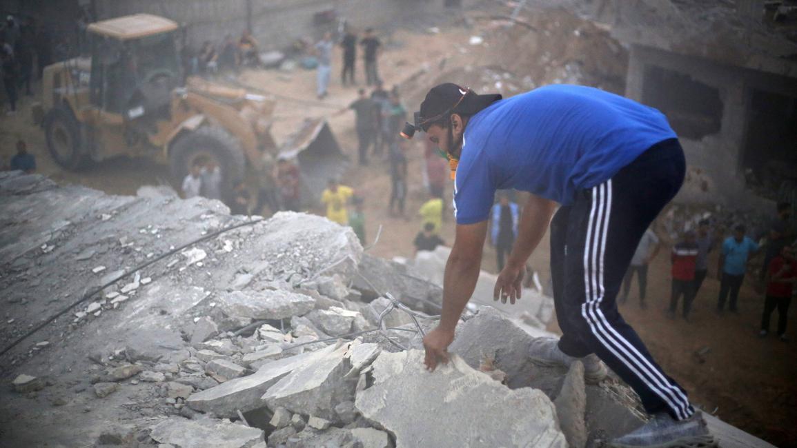 فلسطيني يبحث عن ضحايا في الموقع (أحمد زقوت/Getty)