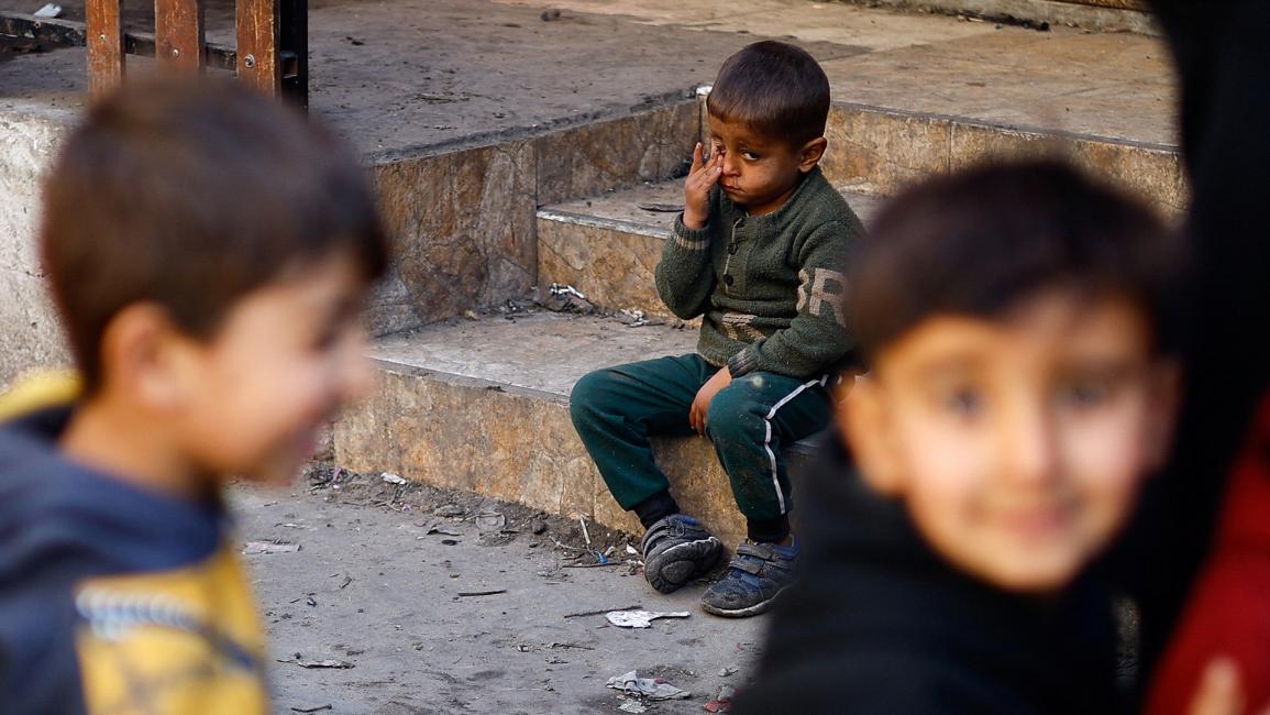 طفل فلسطيني يجلس من التعب في محاوله للحصول على الطعام (رويترز/إبراهيم أبو مصطفى)