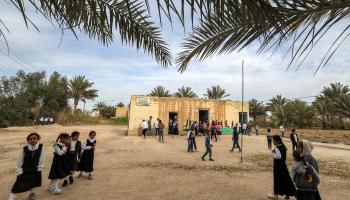 تلاميذ خارج المدرسة المبنية من الطوب (أحمد الربيعي/ فرانس برس)