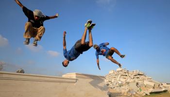 لاعبو الباركور الفلسطينيون يقفزون فوق أنقاض المباني (حسن جدي/الأناضول)